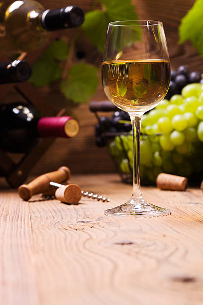istock Glass of white wine, served with grapes 487164016