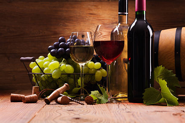 istock Glasses of red and white wine, served with grapes 487166410