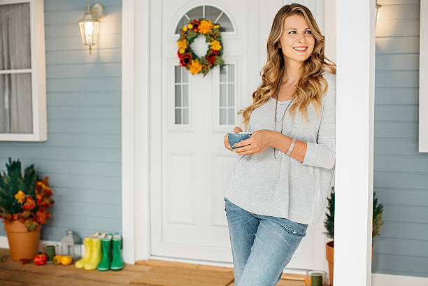 istock Woman in front of a house. 487166846