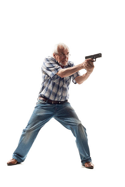пожилой человек принимает цель с пистолет - death fear focus on shadow isolated objects стоковые фото и изоб�ражения