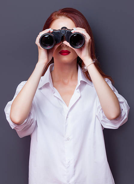 istock businesswomen in white shirt with binocular 487168384