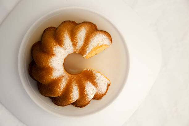 Top view of a Ring-shaped morning cake, known as Bundt cake or Gugelhupf in the rays of rising sun. Optimistic image similar to infographics diagram or pie chart for a concept of lifestyle, business or finance.