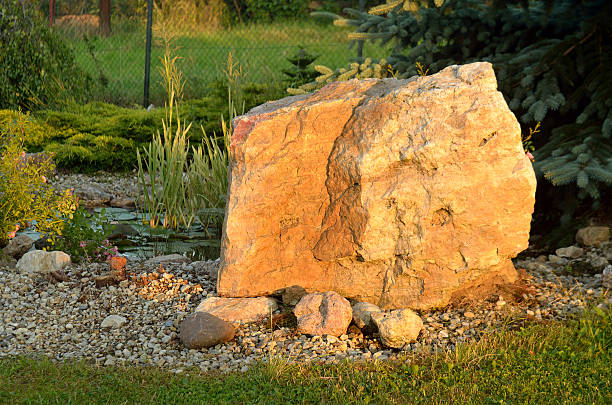 Huge stone and decorative garden pond at sunset