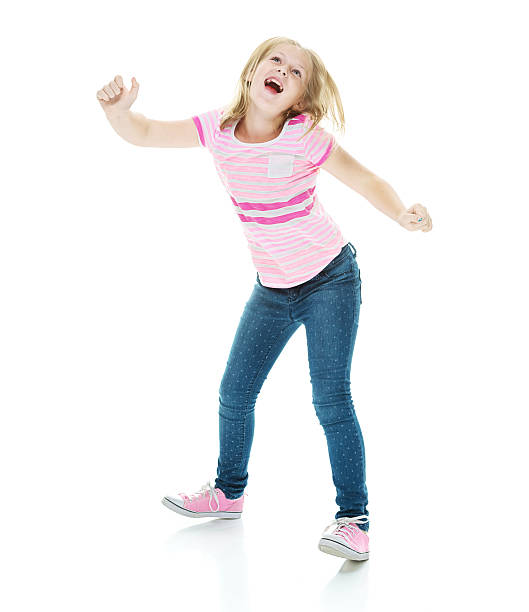 istock Smiling little girl dancing 487171796