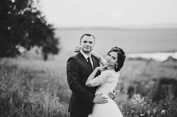 istock Wedding  couple together posing during sunset at summer field. 487171988
