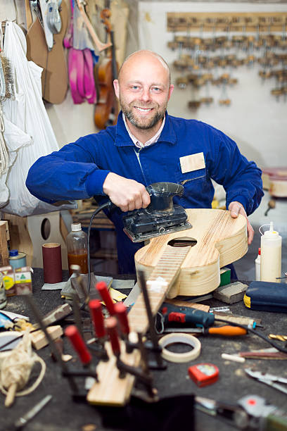 istock Man polishing guitar's body 487172190