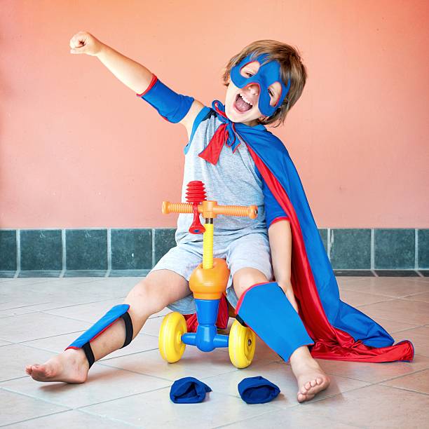 istock Little Superhero Riding a 4 Wheels Toy Vehicle 487172872