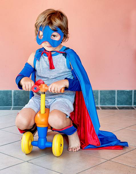 istock Little Superhero Riding a 4 Wheels Toy Vehicle 487172888