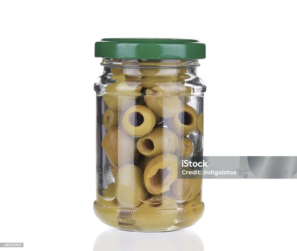 Glass with green olives. Glass with green olives. Isolated on a white background. Backgrounds Stock Photo