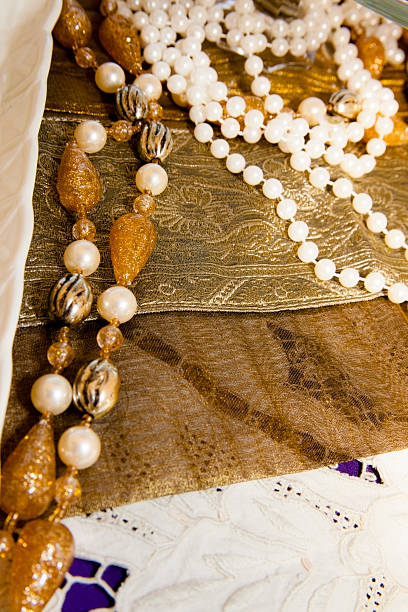 istock Antique pearls and beads on old-fashioned table linens. 487173337