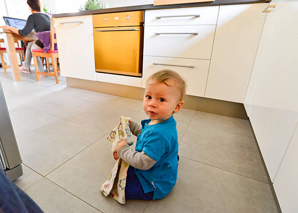 istock Woman working on computer at home, baby playing on floor 487173458