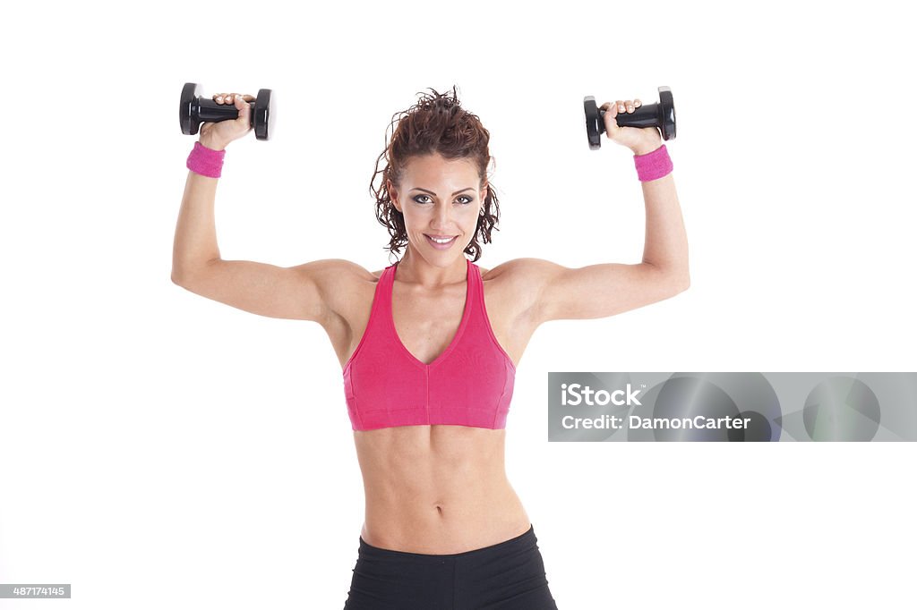 Young fitness woman training with weights Fitness woman doing exercises with various tools on white background Active Lifestyle Stock Photo