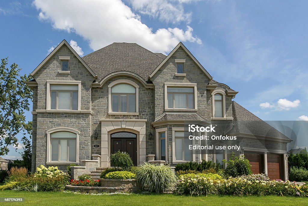 Luxury Suburban House Exterior in Summer Laval, Canada- August 10, 2008: Luxurious house located in Laval, suburb region of Montreal, during a sunny day of Summer Home Ownership Stock Photo