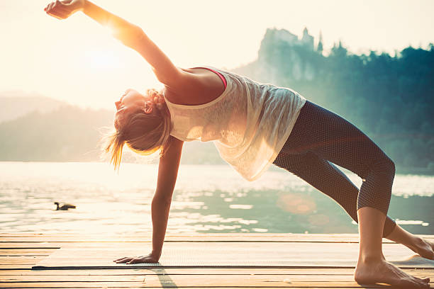 istock Sunset Yoga by the water 487175800