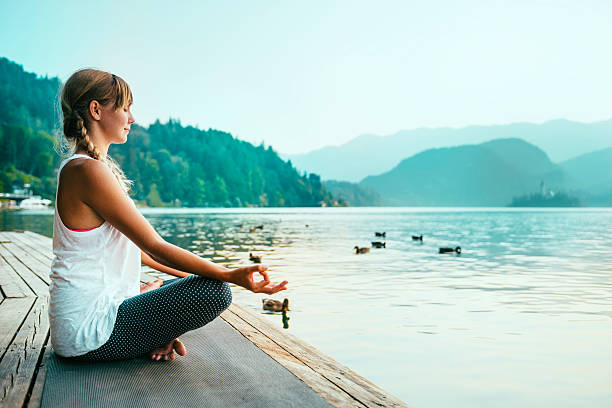 istock Meditating by the lake 487175812