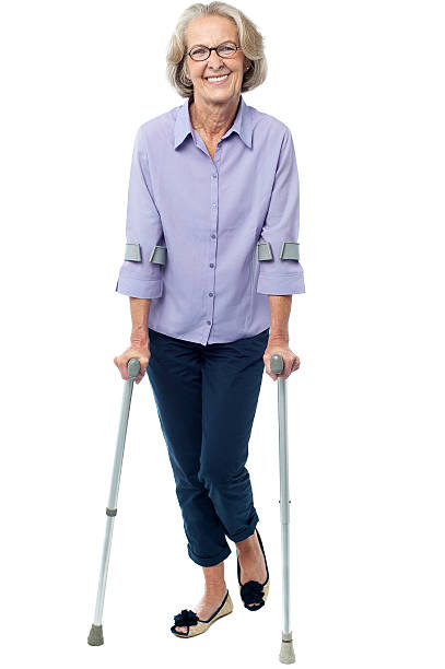 istock Old woman walking with crutches 487175819