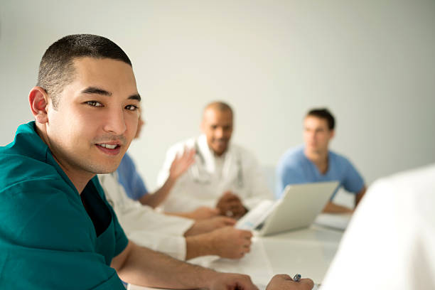 istock Asian doctor on meeting in doctor's office looking at camera. 487176128