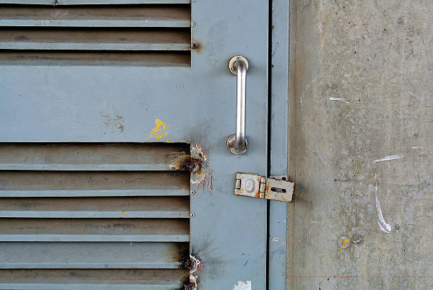 istock Closeup grunge metal door with lock 487176242