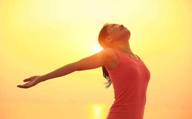 istock cheering woman open arms under  sunrise on beach 487176433