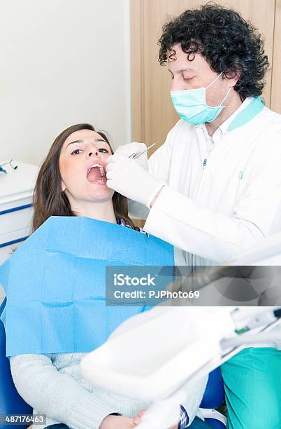 Dentist At Work With Dental Tools Stock Photo - Download Image Now - 20-24 Years, 40-44 Years, Adult