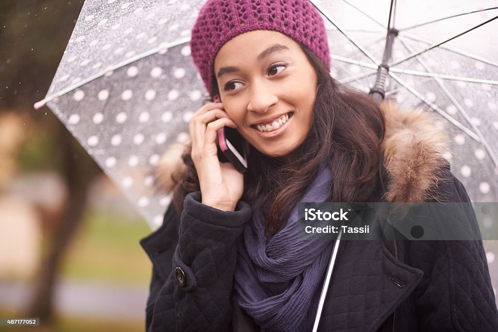 Yep, my weather app was right! Shot of a young woman talking on her phone while out for a walk on a rainy dayhttp://195.154.178.81/DATA/i_collage/pu/shoots/805464.jpg 20-29 Years Stock Photo