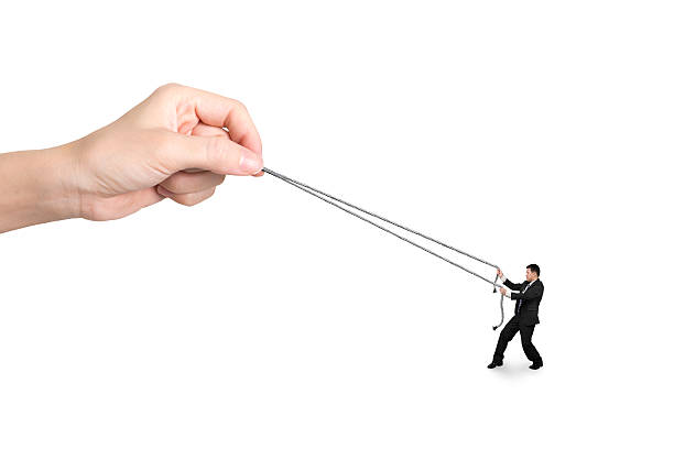 istock Businessman pulling rope against big woman hand 487177098