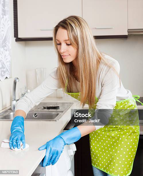 Housewife Cleaning Furniture In Kitchen Stock Photo - Download Image Now - 30-39 Years, Adult, Adults Only