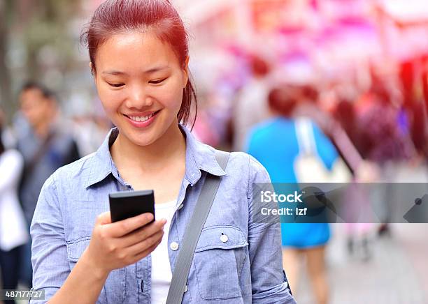 Woman Using Her Mobile Phone On The Street Stock Photo - Download Image Now - Adult, Adults Only, Asian Culture