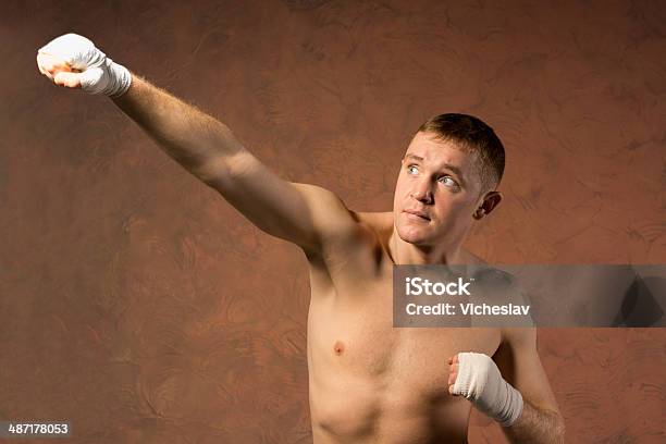 Young Boxer Throwing An Upwards Punch Stock Photo - Download Image Now - Adolescence, Adult, Adults Only