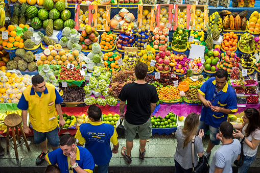 Sao Paulo, Brazil - March 14, 2015: People grocery shopping at the traditional Municipal Market (Mercado Municipal) in Sao Paulo, Brazil.