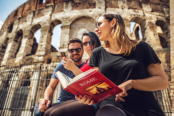Tourists with a guide in front of the Coliseum, Rome