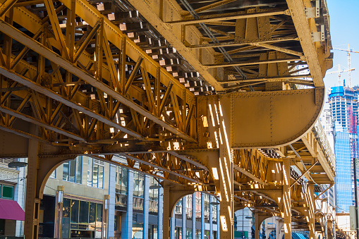 Photo taken under the metallic structure of the urban train called el or loop, located at chicago's downtown