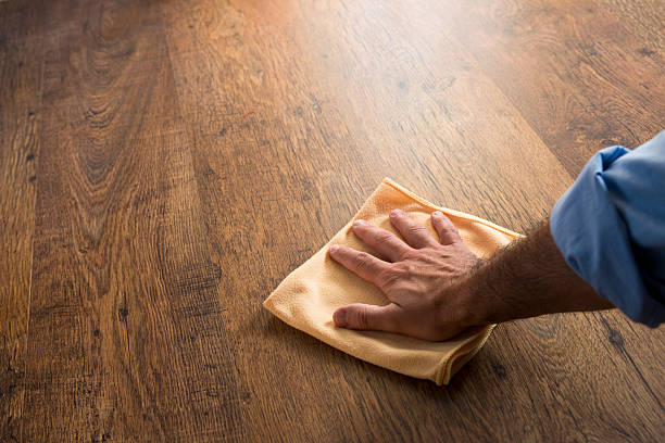 Hardwood floor manteinance Male hand cleaning and rubbing an hardwood floor with a microfiber cloth. microfiber stock pictures, royalty-free photos & images