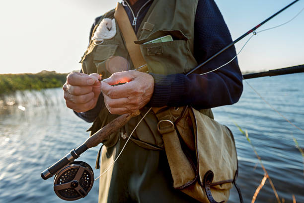 istock Close Up Of Fisherman's Hands Tying a Fly 487186596