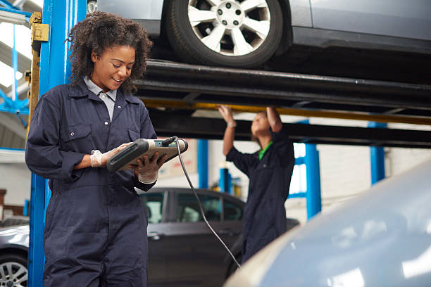 istock female garage mechanic conducting diagnostic check. 487191188