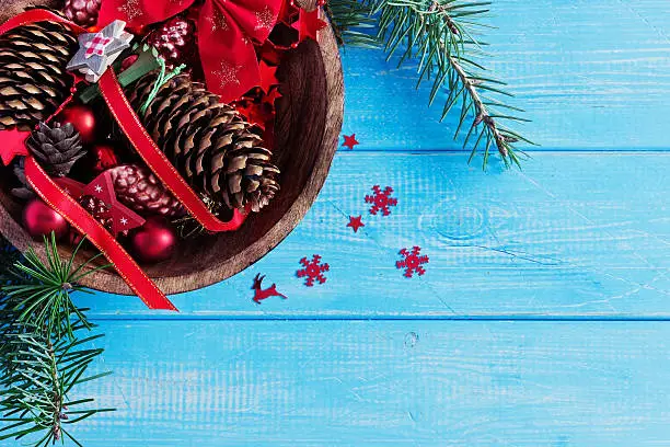 christmas decoration in a wooden bowl on a blue wooden background. christmas motifs. top view.