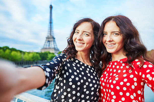 istock Beautiful twin sisters taking selfie in front of Eiffel Tower 487195396