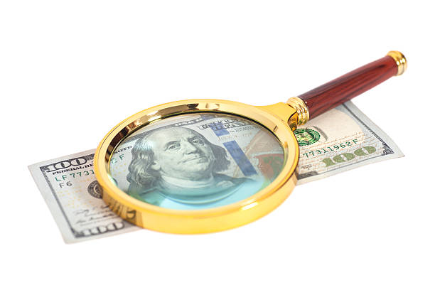 istock Hundred dollar banknote under magnifying glass 487200226