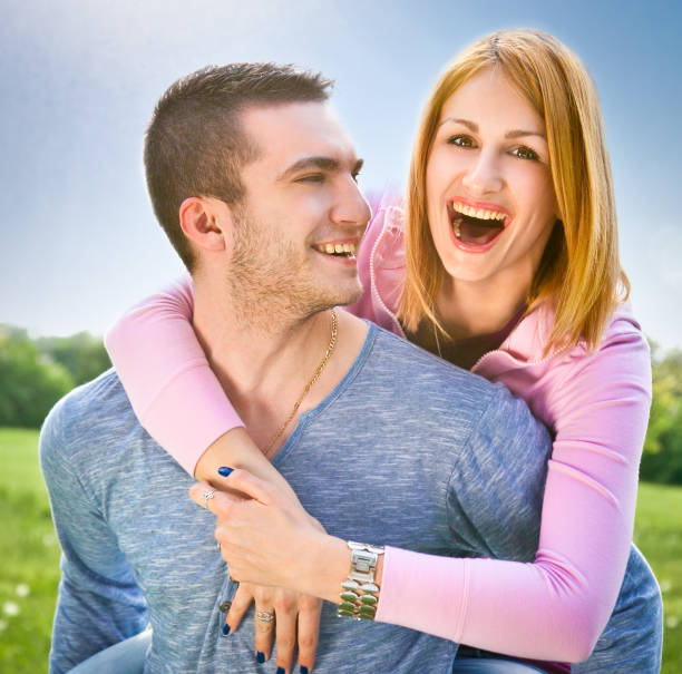 istock Smiling young couple have a fan in spring park 487200755