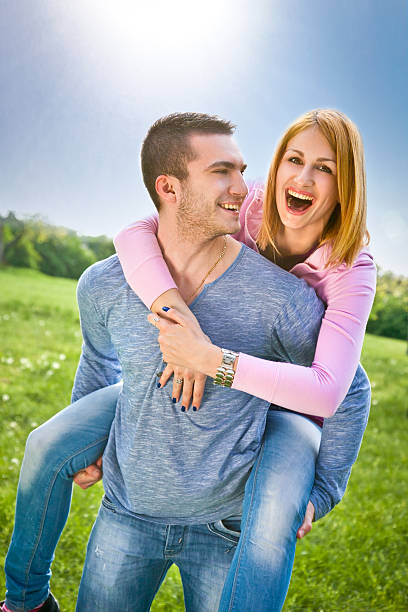 istock Smiling young couple have a fan in spring park 487200765