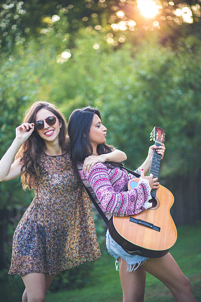 istock Beautiful stylish friends playing guitar 487202298