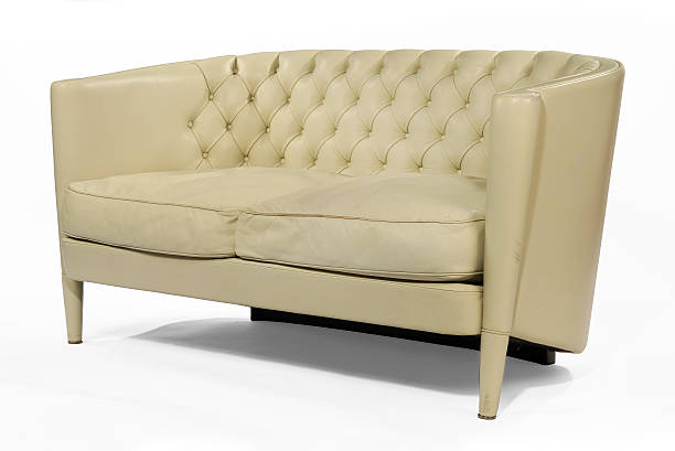 istock Antique retro sofa couch cream leather isolated on white 487202334
