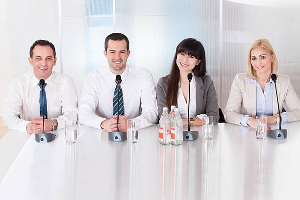 Group Of Business People Sitting In Conference Happy Group Of Business People Sitting In Conference interview seminar microphone inside of stock pictures, royalty-free photos & images