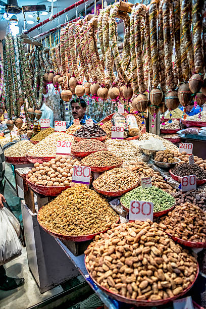 Dried fruits and seeds store at Old Delhi's spice market Old Delhi, India - March 8, 2014: Seeds, nuts and spices store in the Old Delhi, Chandni Chowk spice market district. Seller is visible at the background. old delhi stock pictures, royalty-free photos & images