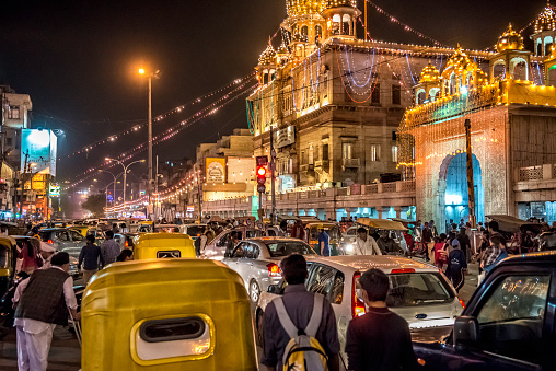 Old Delhi, India - March 8, 2014: Pedestrians on busy streets of Khari Baoli  leading to Old Delhi spice market at night.