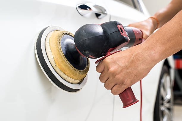 istock Car polishing series : Worker waxing white car 487204846