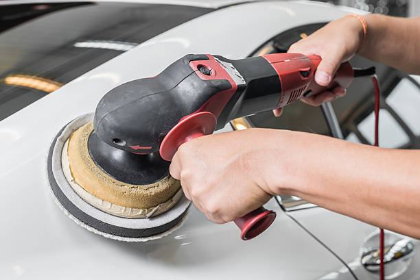 istock Car polishing series : Worker waxing white car 487205292