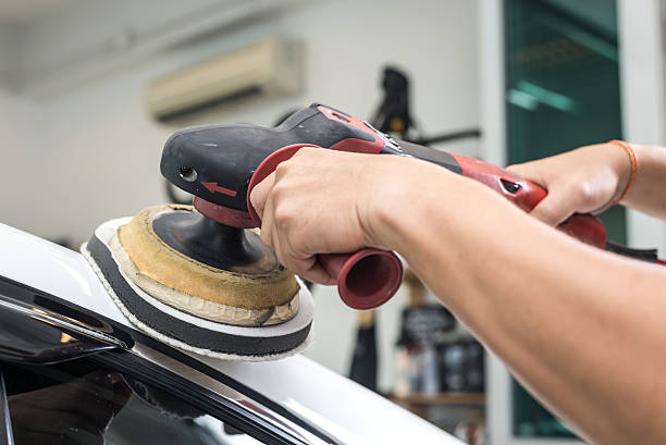 istock Car polishing series : Worker waxing white car 487205296