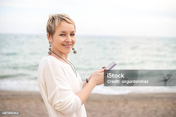 Woman Using Smart Phone Stock Photo - Download Image Now - Beach, Smart Phone, 2015