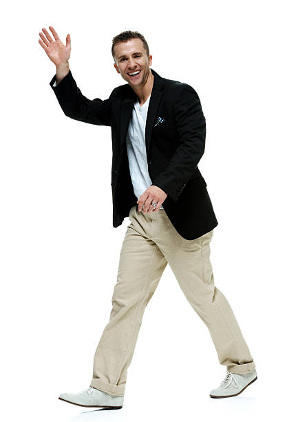 istock Smart casual man waving hand and walking 487205432